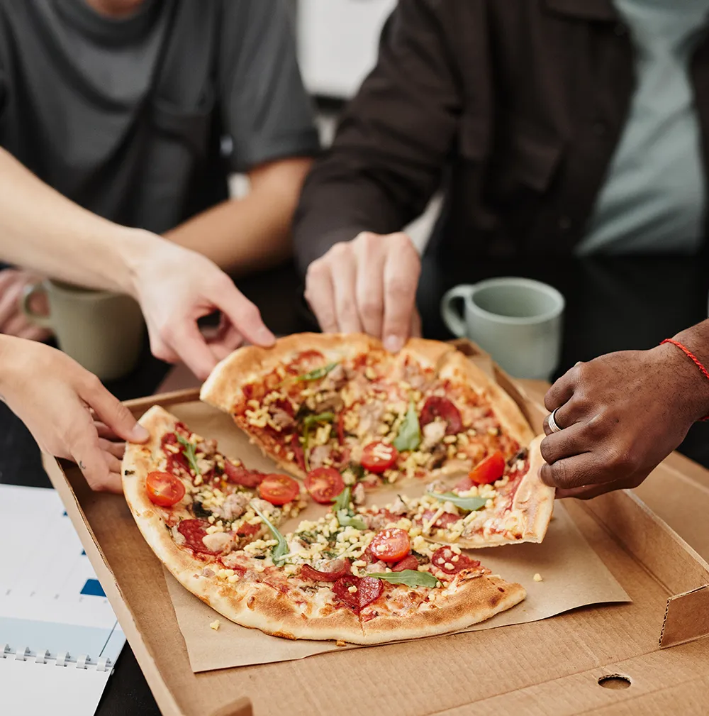 Office people sharing a pizza at the office